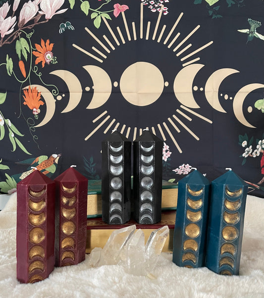 Decorative candles with moon phases against a mystical background with crescent moons and floral elements.