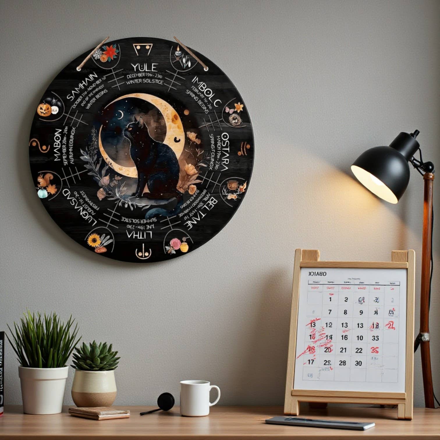 Decorative wall hanging with a cat and moon design on a wall above a desk.