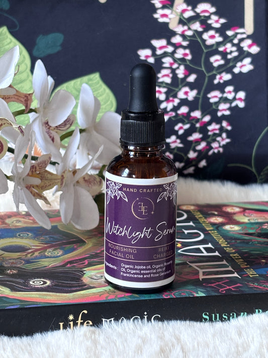 Bottle of Witchlight Serum on a colorful surface with flowers in the background
